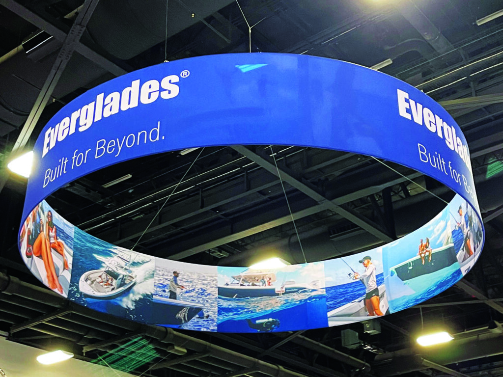 trade-show-hanging-overhead-sign-for-charter-fishing Custom hanging overhead sign for charter fishing trade show booth featuring bold graphics and nautical branding
